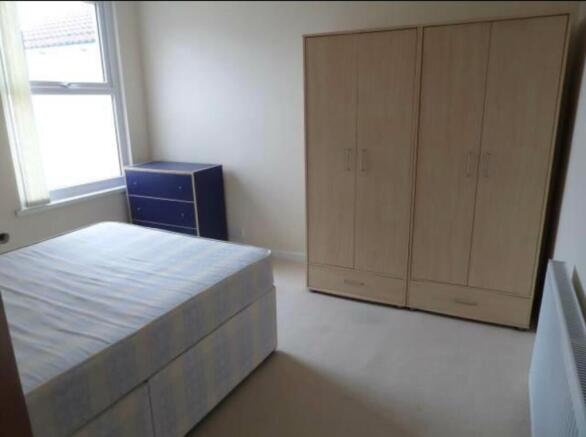 Bright furnished bedroom with a double divan be...