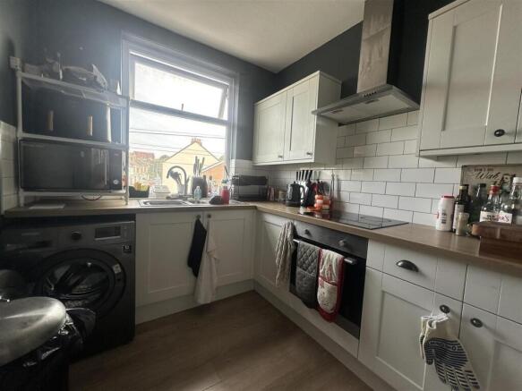 Modern kitchen with subway tiles and natural li...