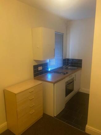 Compact kitchenette with built-in oven, hob and...