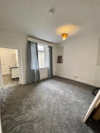 Spacious modern bedroom with plush grey carpet...