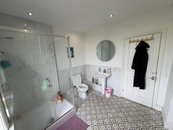 Bright bathroom with stylish patterned flooring...