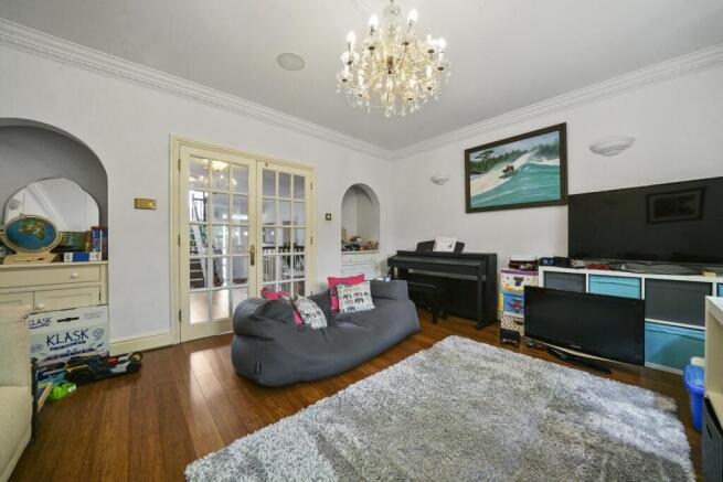 Spacious lounge with elegant chandelier and rug...