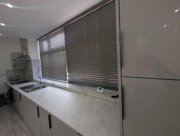 Sleek modern kitchen with stylish grey units...