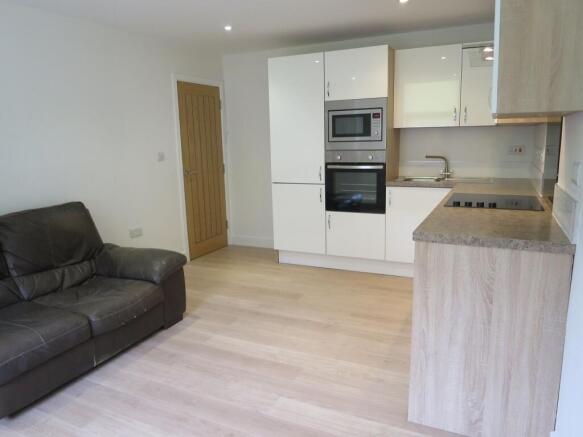 Bright open-plan living area with modern fitted...