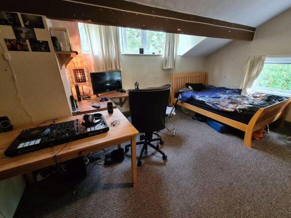 Bright and spacious master bedroom featuring a ...