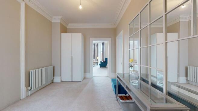 A bright and elegant hallway featuring neutral ...