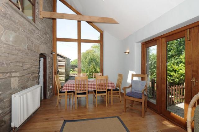 Dining area opening on to streamside terace