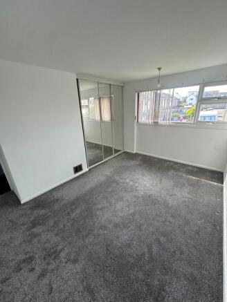 A bright and clean double bedroom featuring a l...