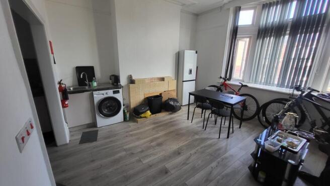 Bright communal lounge with large bay windows, ...