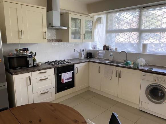 Bright modern kitchen with integrated appliance...