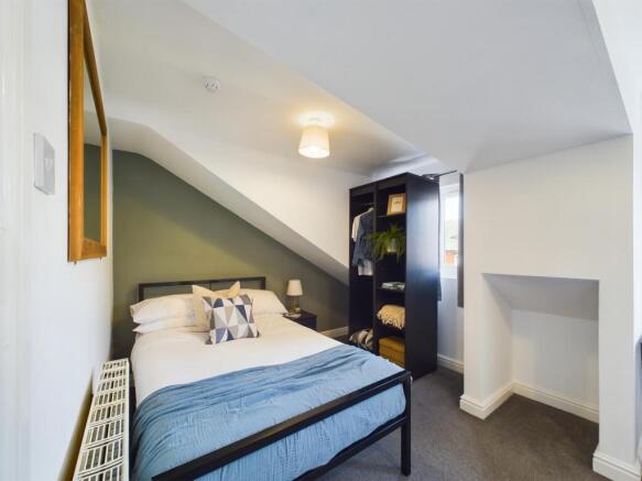 A spacious and well-maintained bedroom with a l...