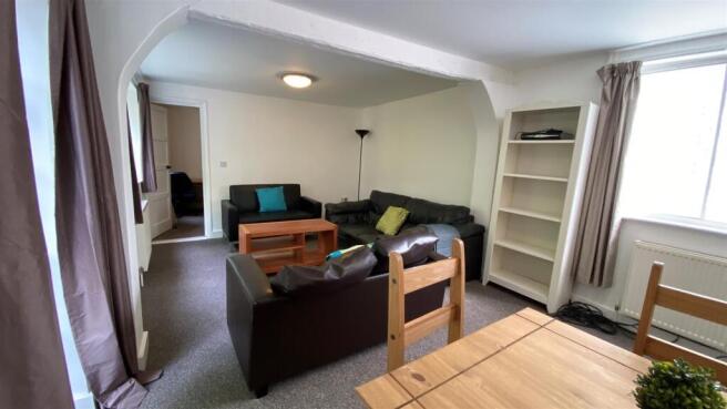 Bright furnished lounge with sofas and dining a...