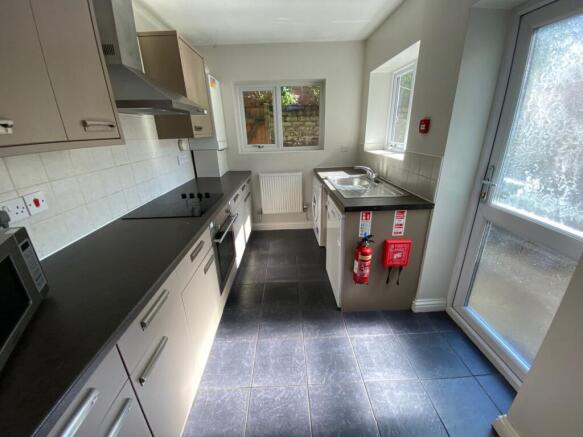 A modern and well-lit kitchenette with ample co...