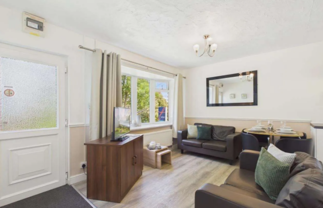Bright Open Plan Lounge With Sofas, Dining Area An