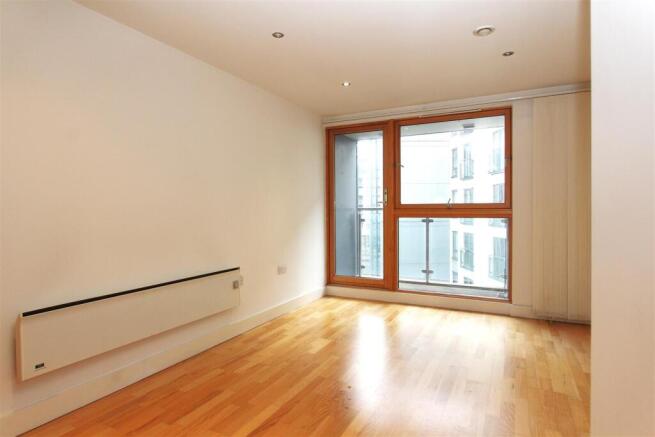 Bright modern bedroom with floor-to-ceiling gla...
