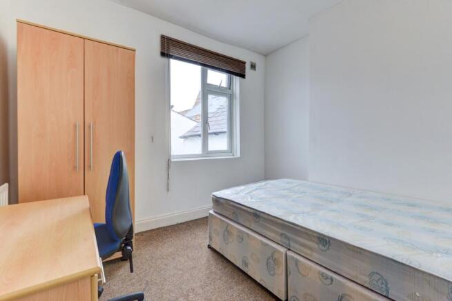 A neatly maintained single bedroom featuring a ...