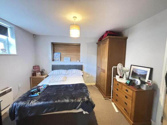 A spacious and well-kept bedroom featuring a la...