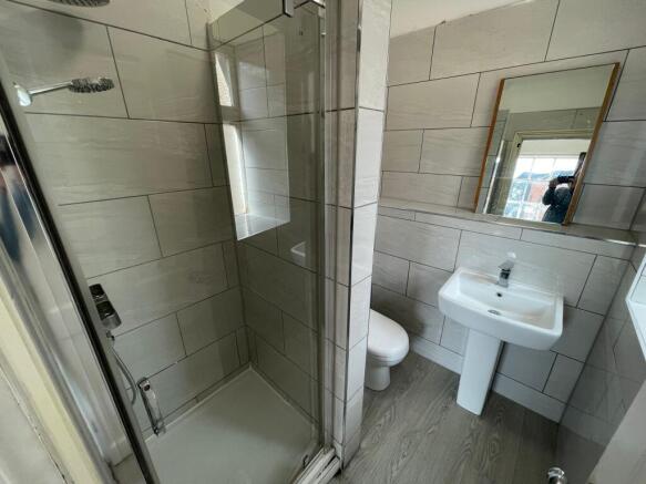 Modern bathroom featuring a glass-enclosed show...