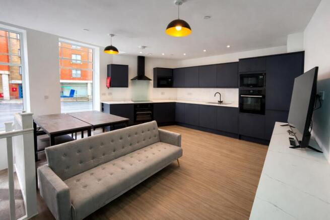Modern open-plan kitchen with seating...