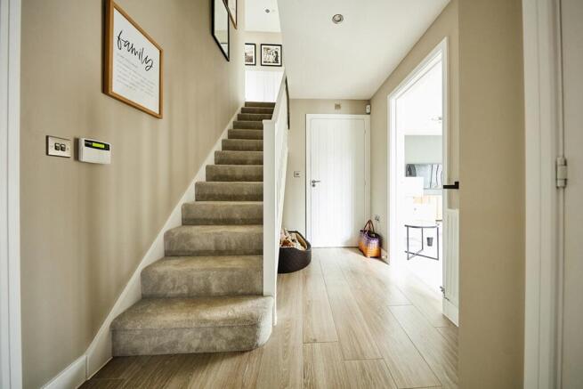 Lounge and kitchen to either side of the hall