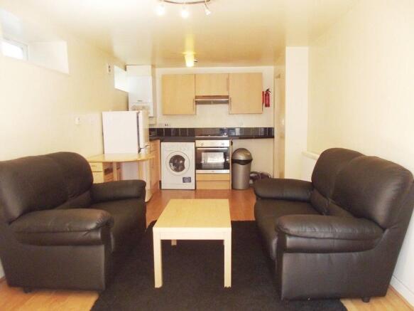 Social living area with comfy sofas and kitchen...
