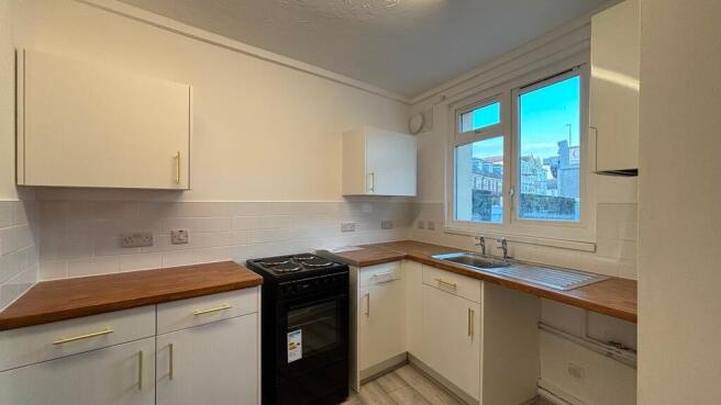 Bright modern kitchen with wooden worktops...