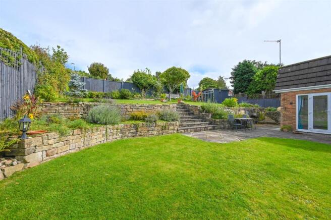 Landscaped gardens and patio areas to rear