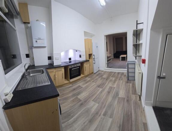 Bright kitchen with ample storage and floor spa...