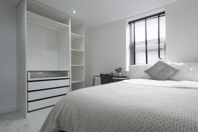 A bright and spacious double bedroom featuring ...