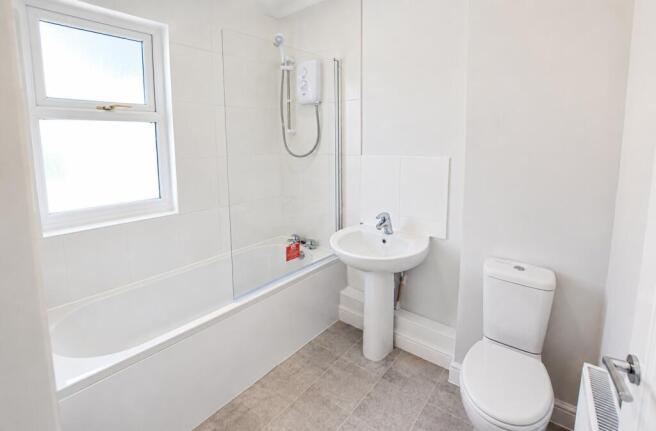 Bright modern bathroom with a full-sized tub...