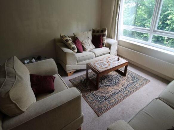 A bright and spacious living room featuring lar...