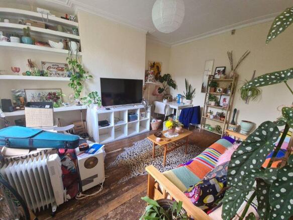 A spacious and welcoming living room filled wit...