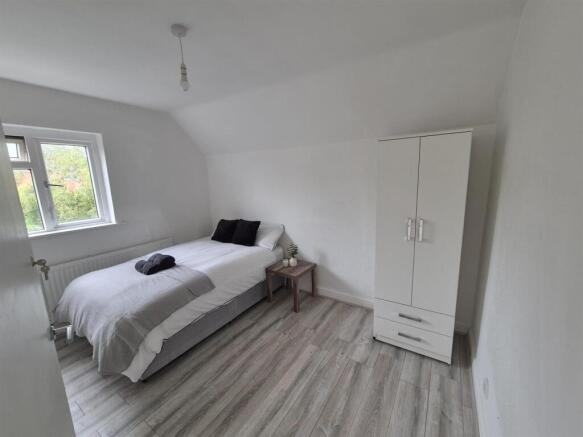 Bright bedroom with wardrobe and wood-style flo...
