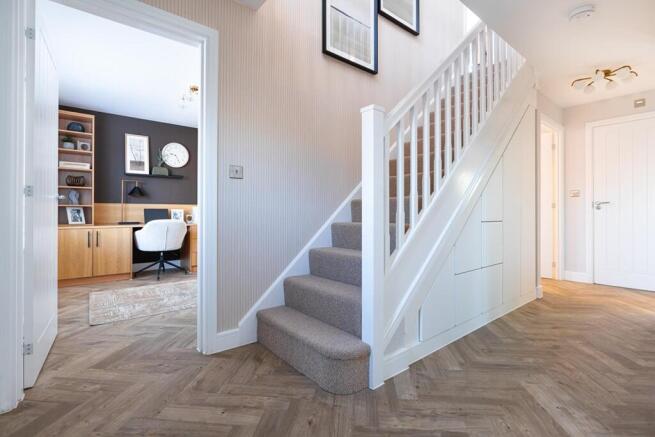 Large and welcoming hallway with storage cupboards