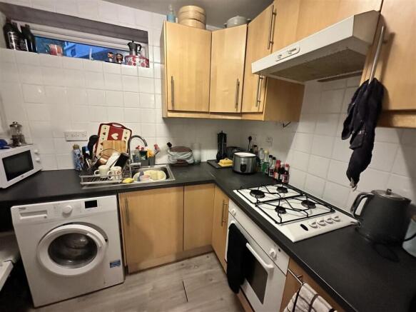 Compact fitted kitchen with appliances and stor...