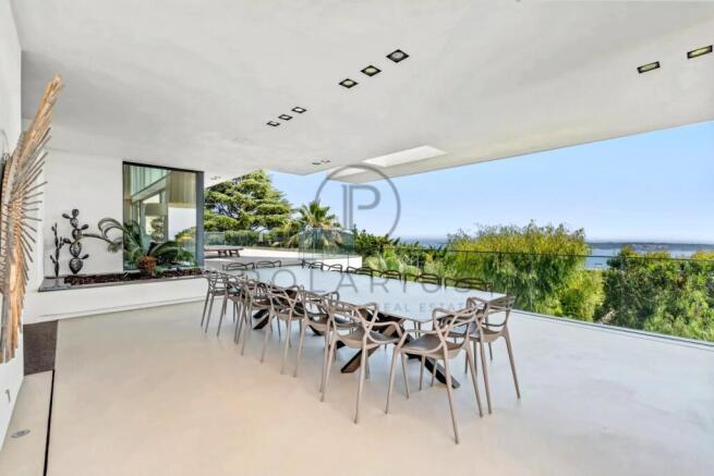 Modern open-air terrace with a long dining table,