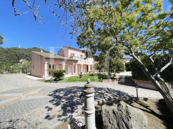 A charming house with a tiled roof is surrounded b