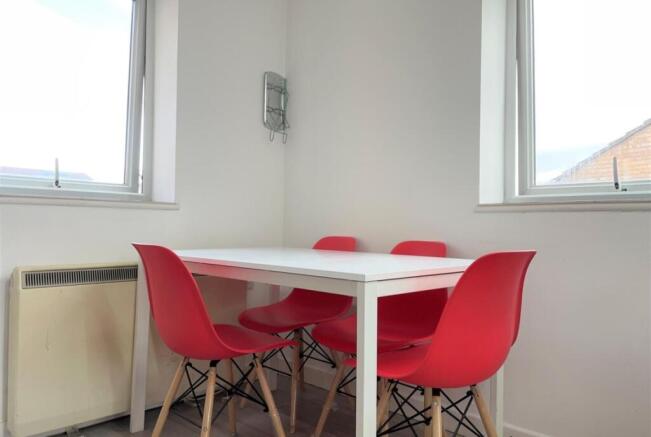 Bright corner dining area with a white table an...