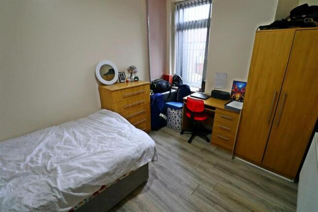 Bright bedroom with desk and ample storage spac...