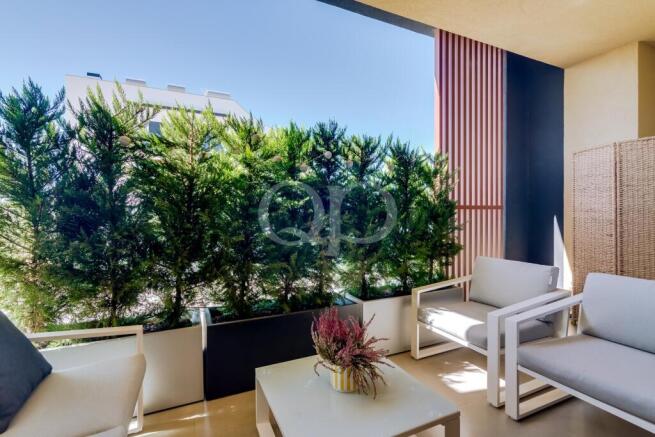 Private apartment terrace with seating and mature screening plants