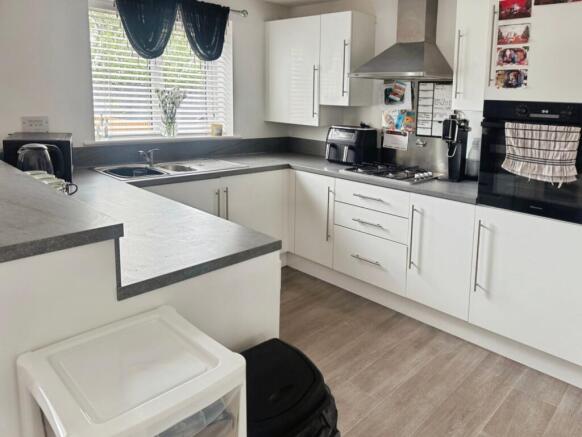 Modern fitted kitchen open to dining room
