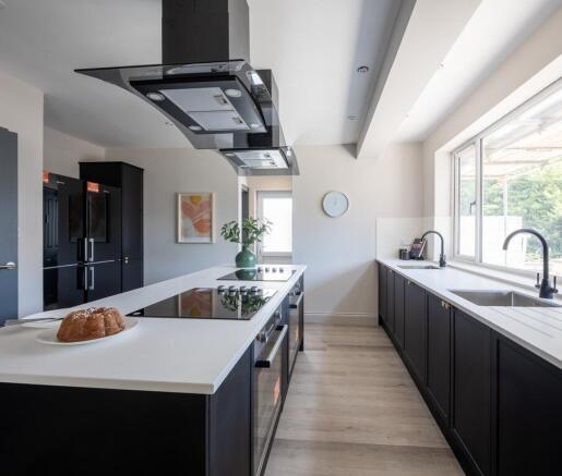 Ultra-modern kitchen with sleek island and ligh...