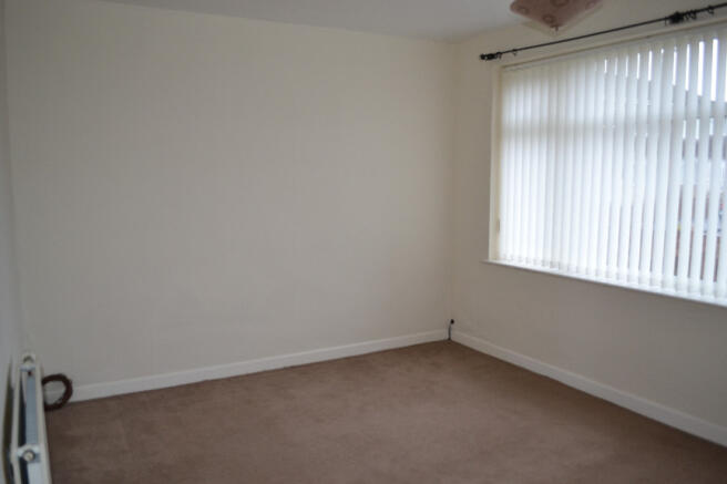 Bedroom With Large Window Overlooking Front