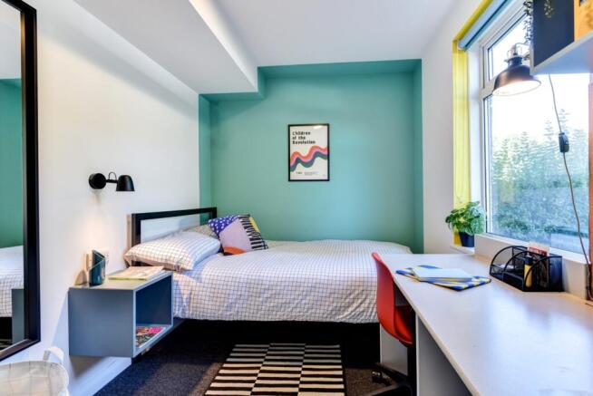 Bright and cozy bedroom featuring a double bed,...