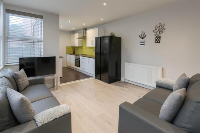 Bright, modern open-plan living area with two c...