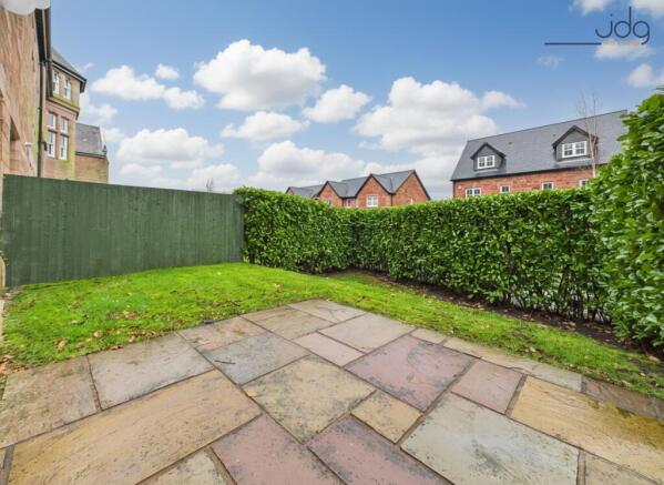 Spacious garden with a mixture of lawn and flagstone