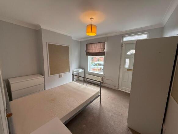 Bright double bedroom with neutral decor, a met...
