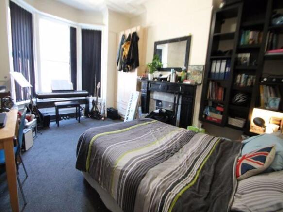 Spacious and well-lit master bedroom featuring ...