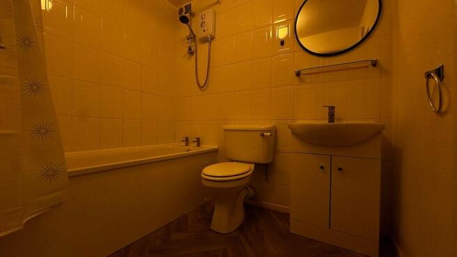 Clean bathroom suite with full tub and vanity...