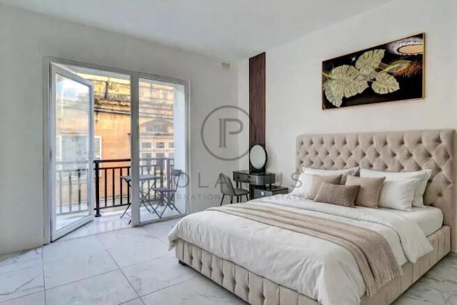 Bright and airy bedroom with a balcony overlooking